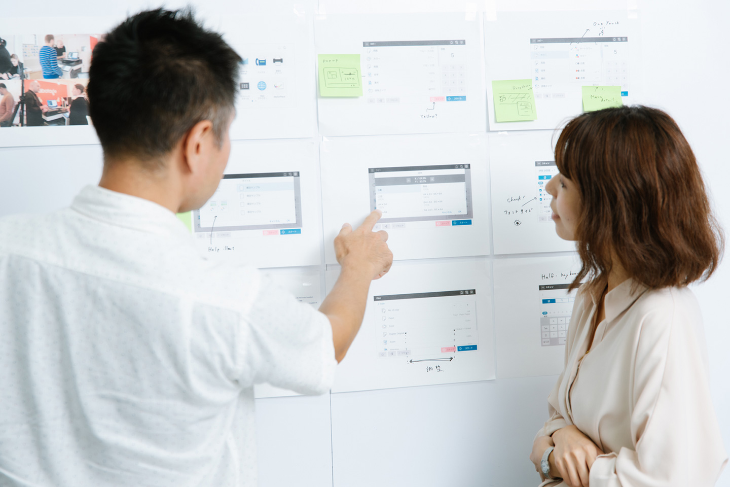 Photograph: Team members reviewing screen layouts at a meeting