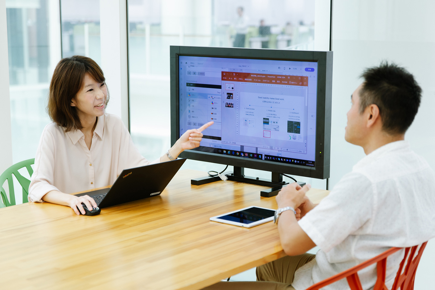 Photograph: Team members viewing a monitor at a meeting