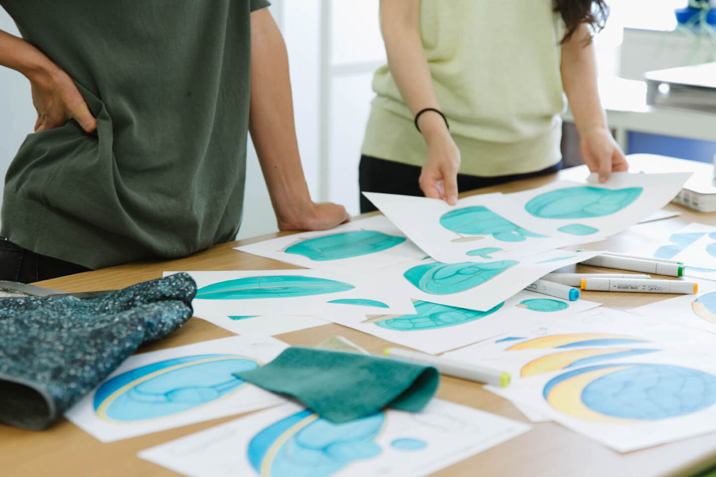 Photograph: Team members viewing seat sketches at a meeting